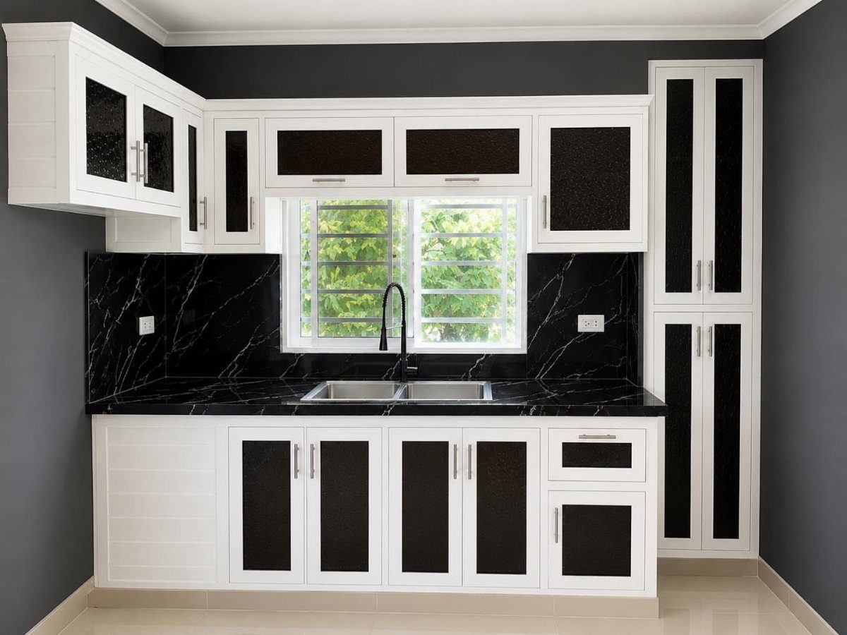 White and black cabinets with black marble countertops and a dark grey wall.