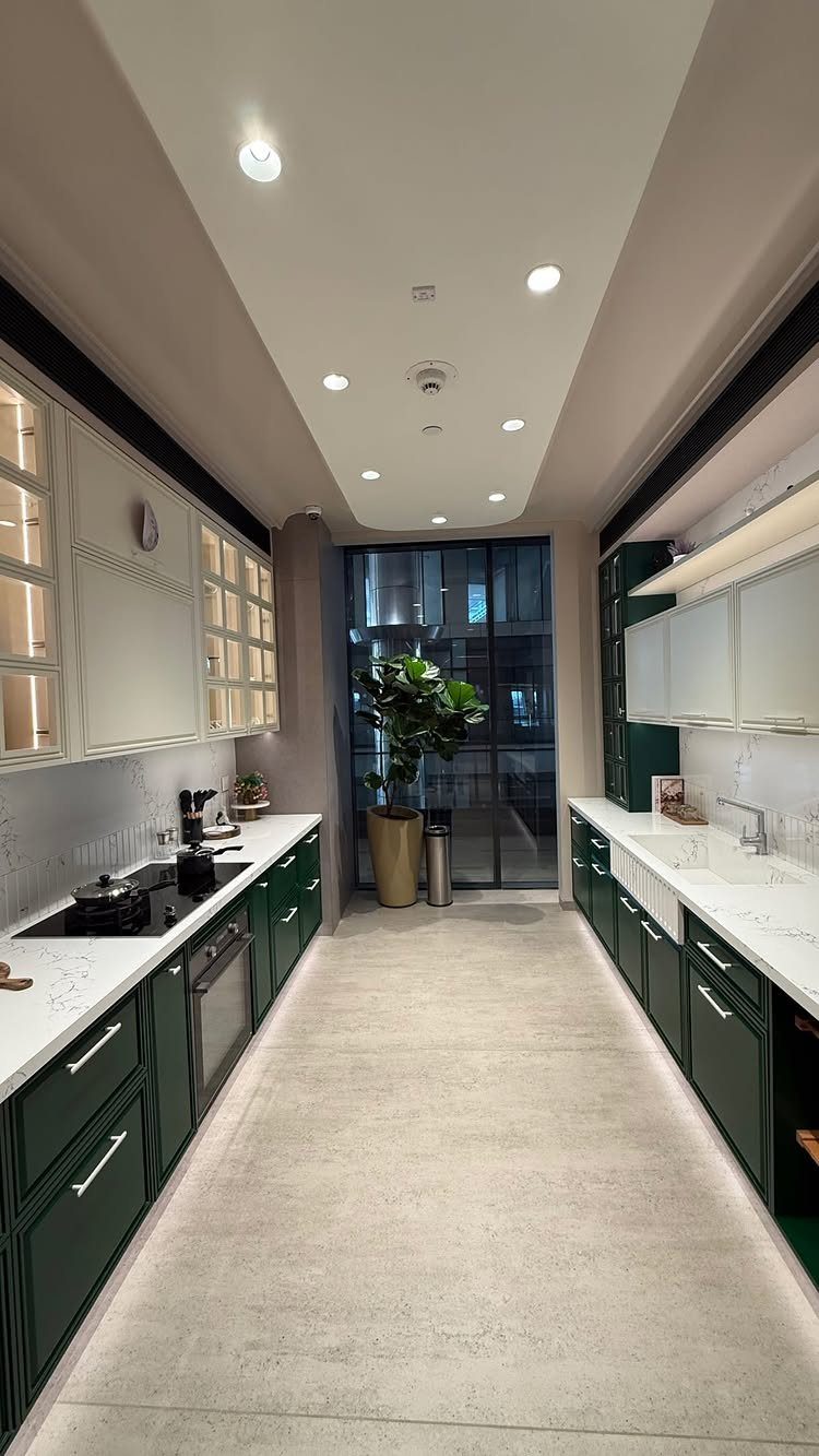 Dark green lower cabinets and white glass-front upper cabinets in a modern kitchen.