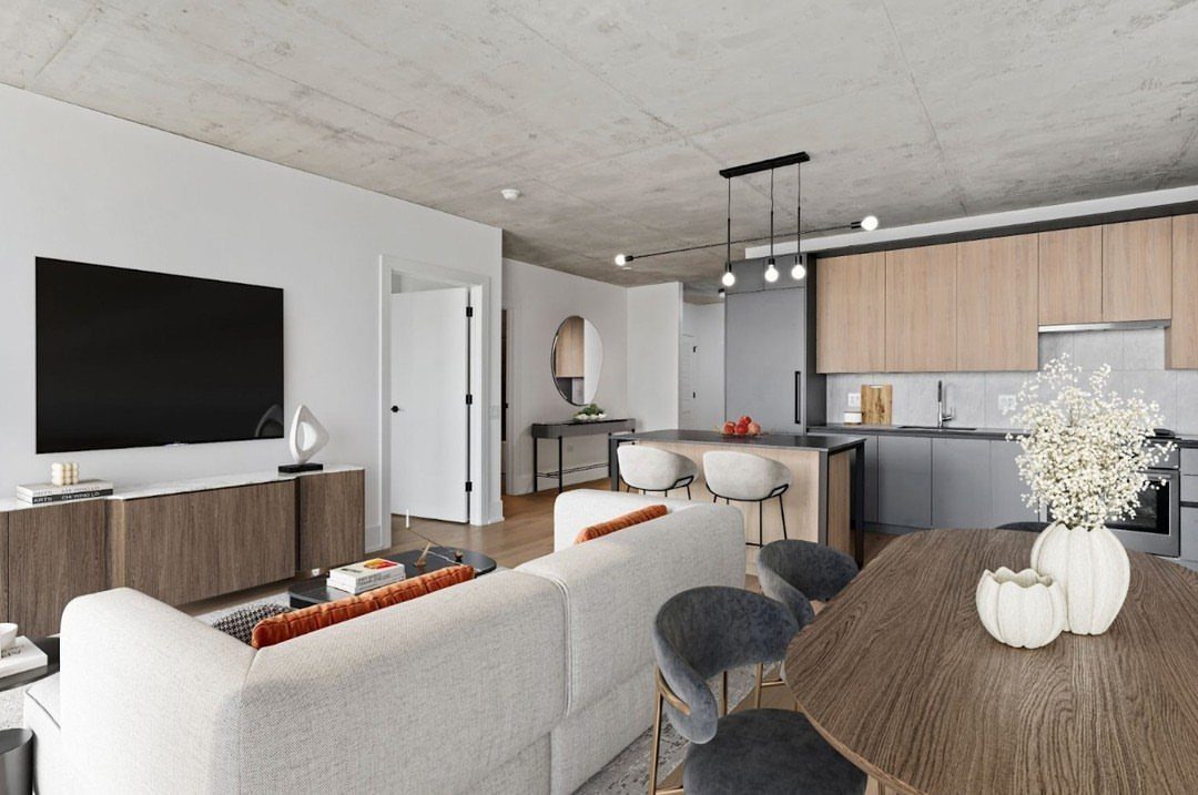 Modern open-concept interior with a raw concrete ceiling and minimalist kitchen design.