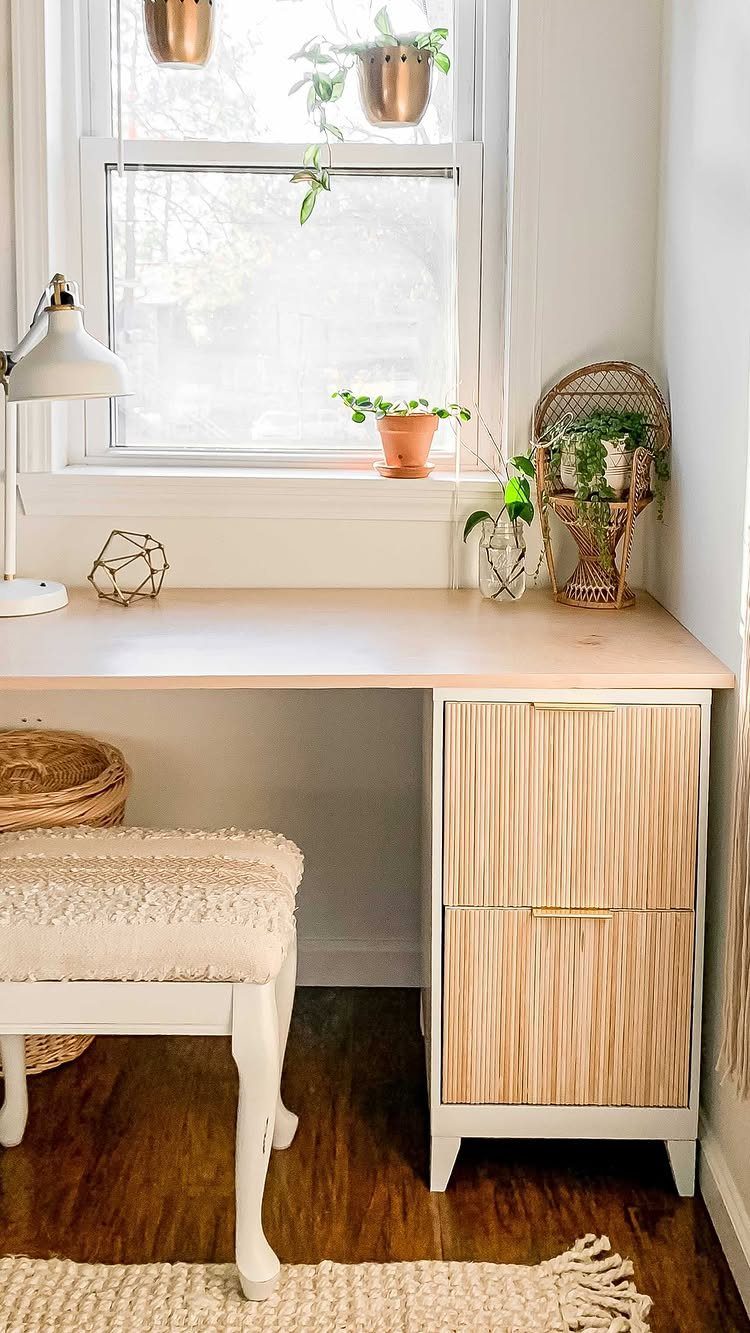 Light wood desk with a white two-drawer file cabinet and white stool.