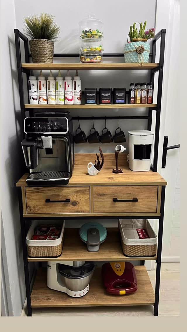 Wooden coffee station shelf with espresso machine, mugs, and storage baskets against white wall