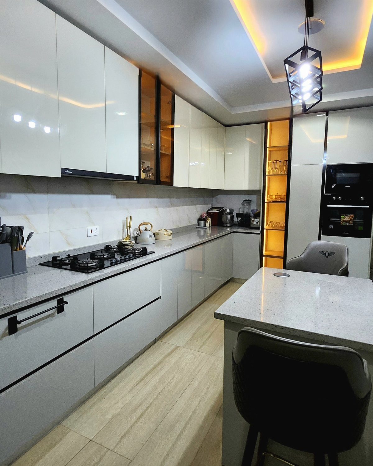 Modern kitchen with white upper and grey lower cabinets and a grey island.