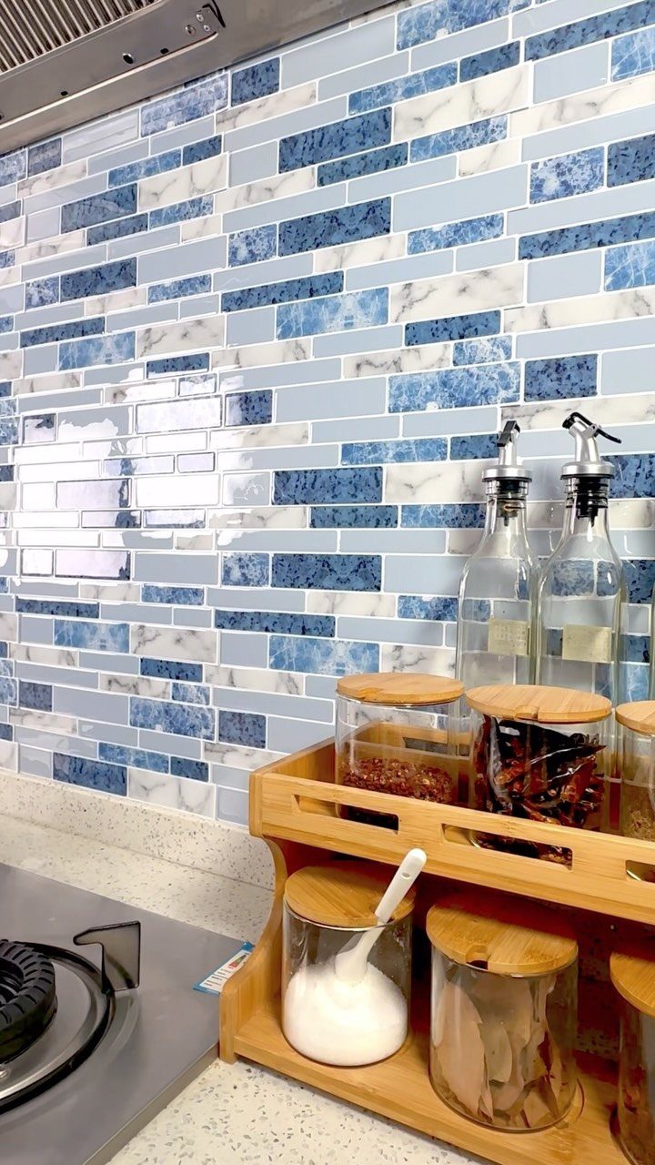 Blue and white marbled rectangular tile backsplash with a wooden spice rack foreground.