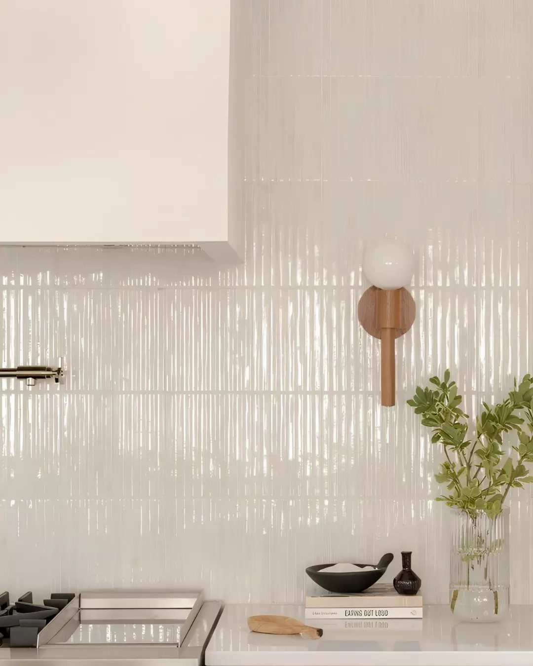 White gloss ceramic picket tile backsplash in a bright kitchen with white cabinets.
