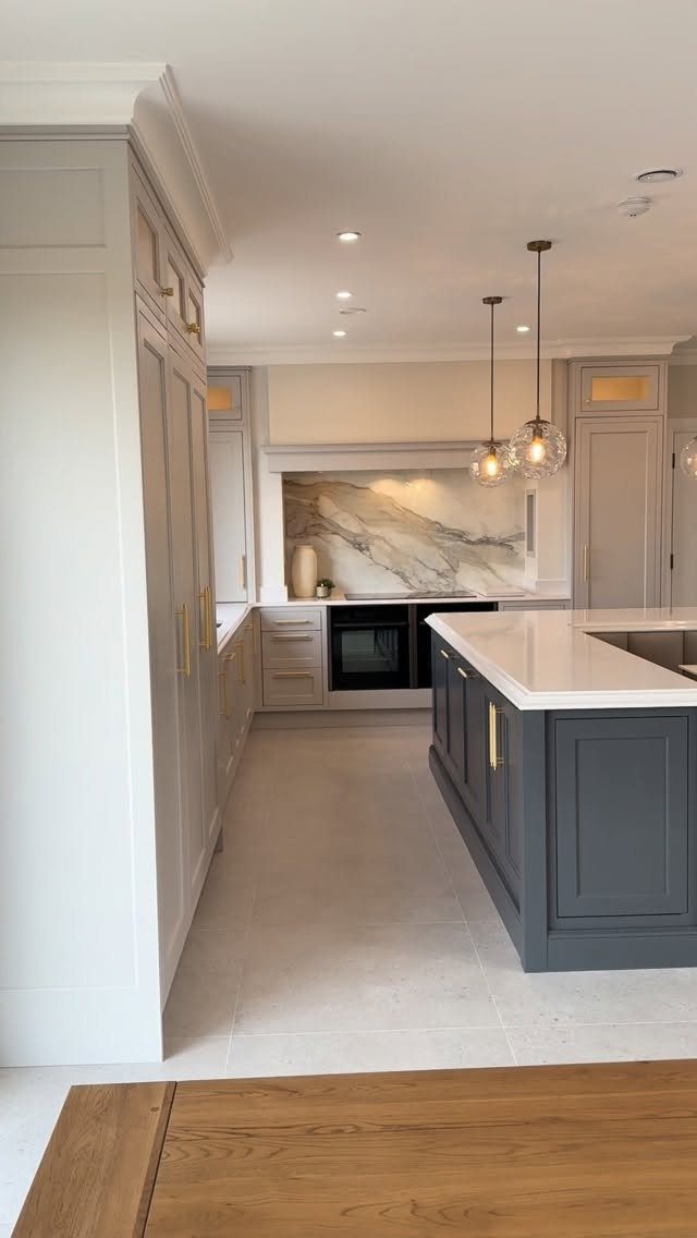 Light gray perimeter cabinets paired with a dark charcoal gray kitchen island.