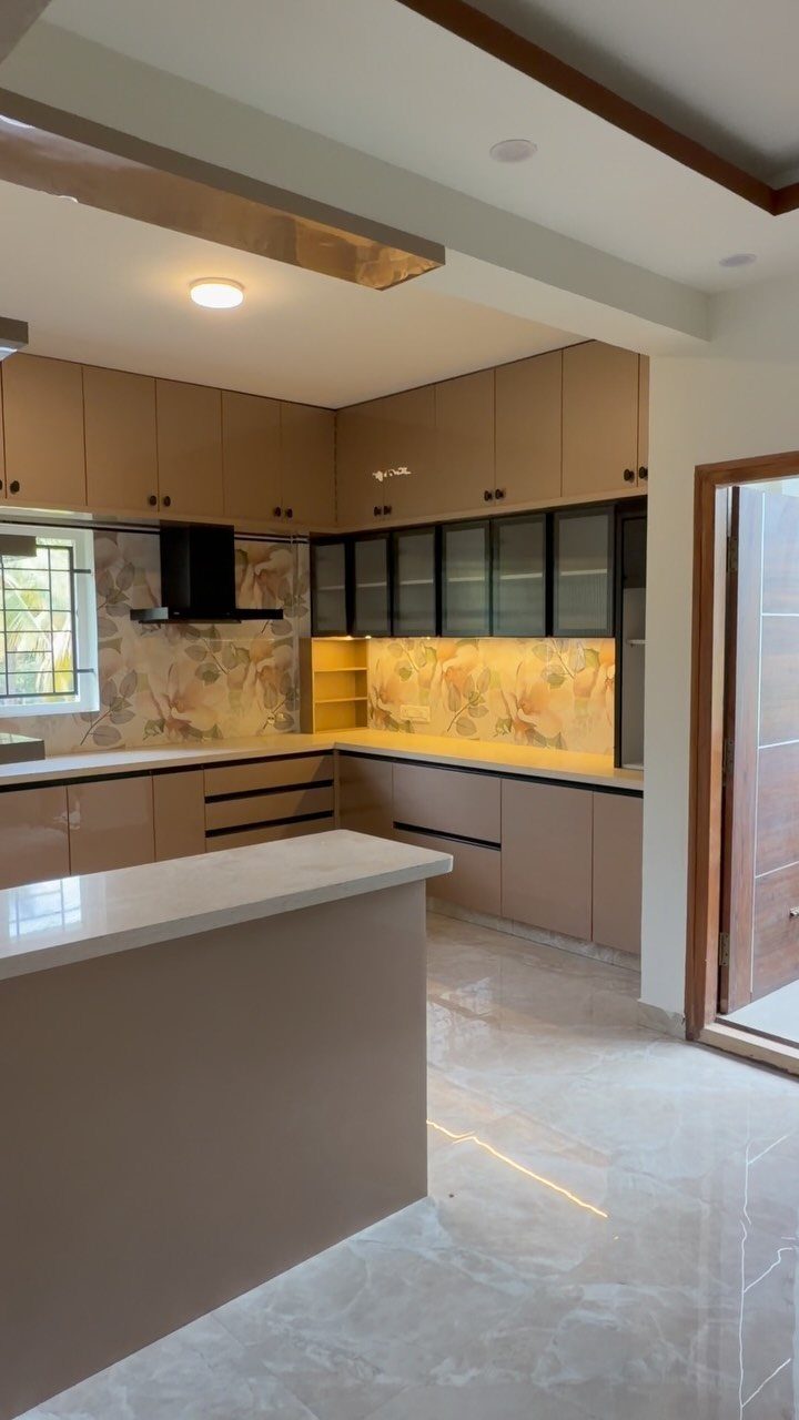 Light brown wood kitchen cabinets with white countertops and a patterned backsplash.
