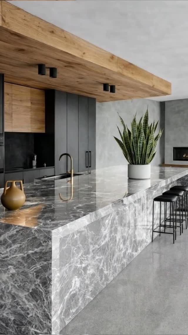 Marble kitchen island with a matching grey veined stone back panel and countertop.