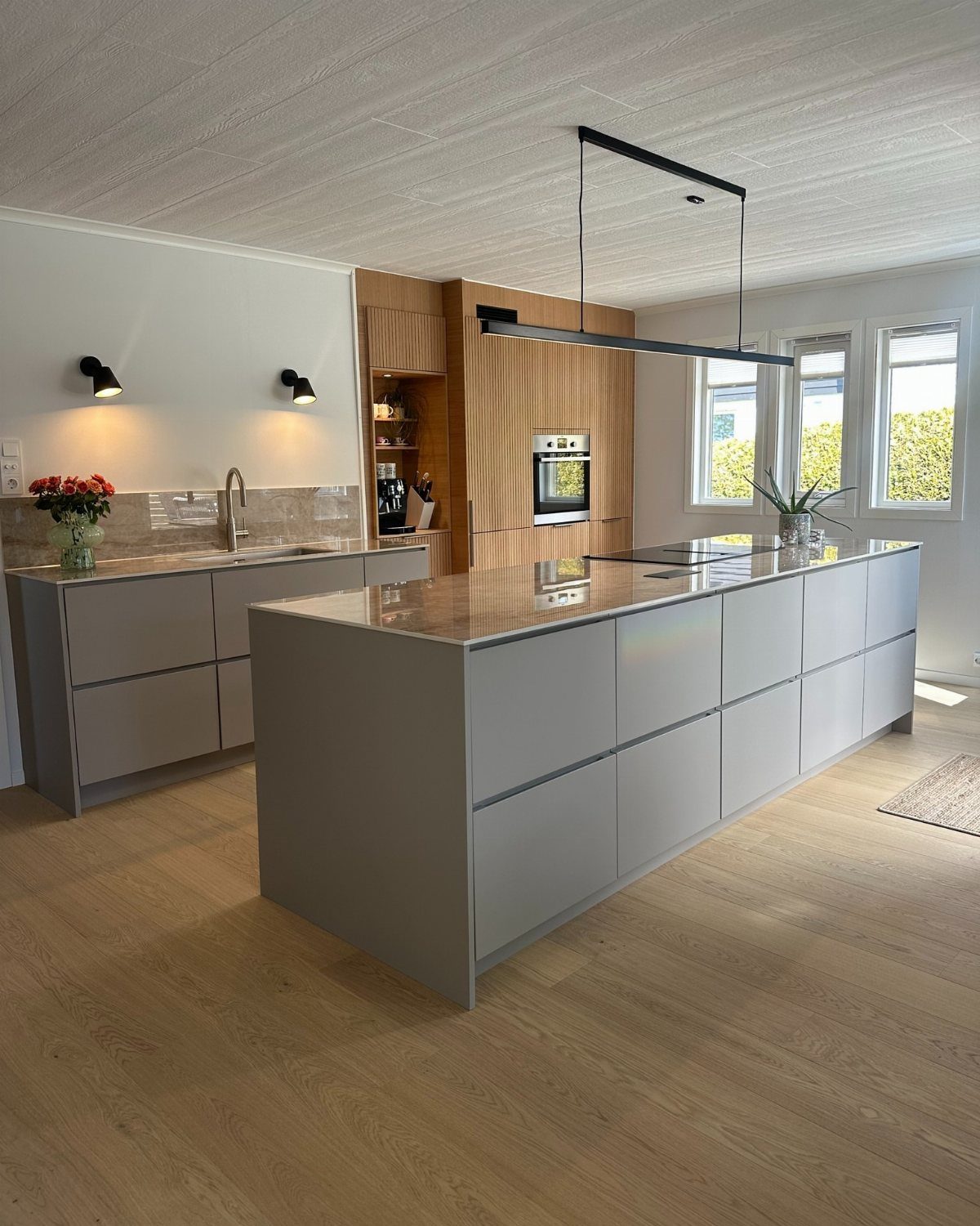Grey kitchen island with integrated drawers and a smooth countertop in modern kitchen