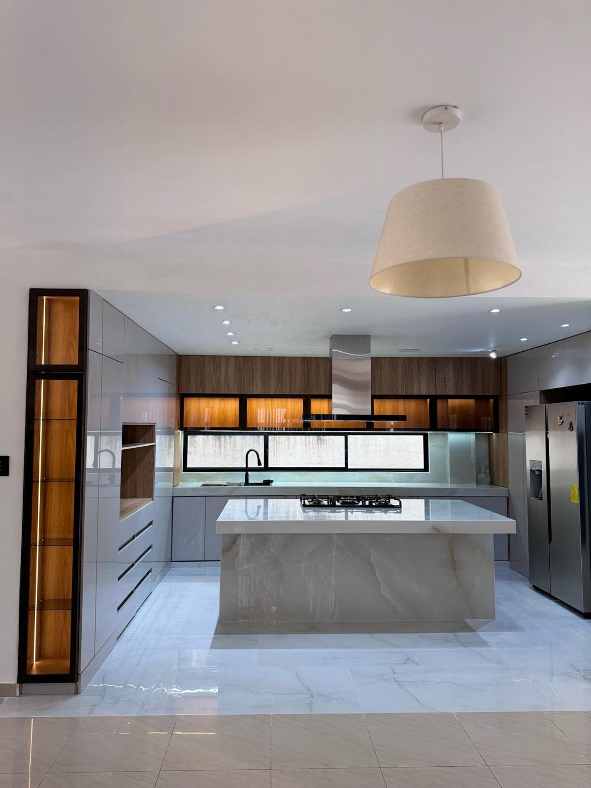 White marble kitchen island with a built-in gas stove in a modern kitchen