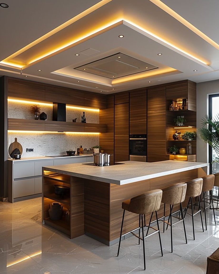 Modern kitchen with a recessed geometric ceiling featuring warm integrated LED strip lighting.