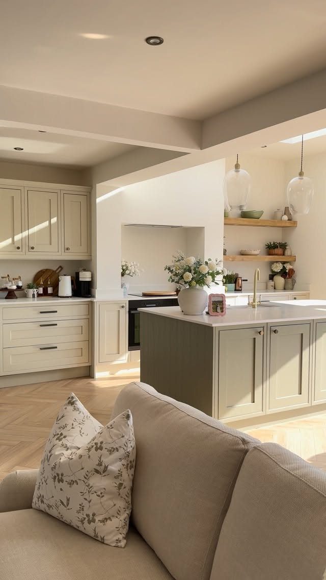 Light wood herringbone floors in an open concept kitchen and living room area