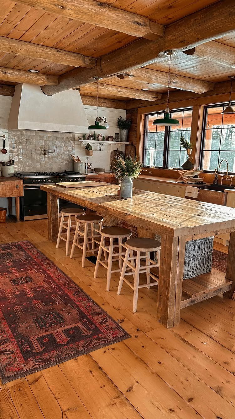 Reclaimed wood kitchen island with wooden stools under heavy timber ceiling beams