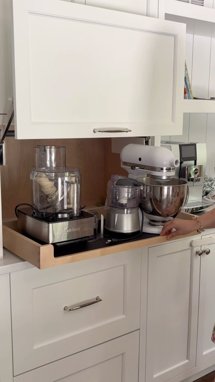 White kitchen appliance garage with a lift-up door holding a mixer and food processor.