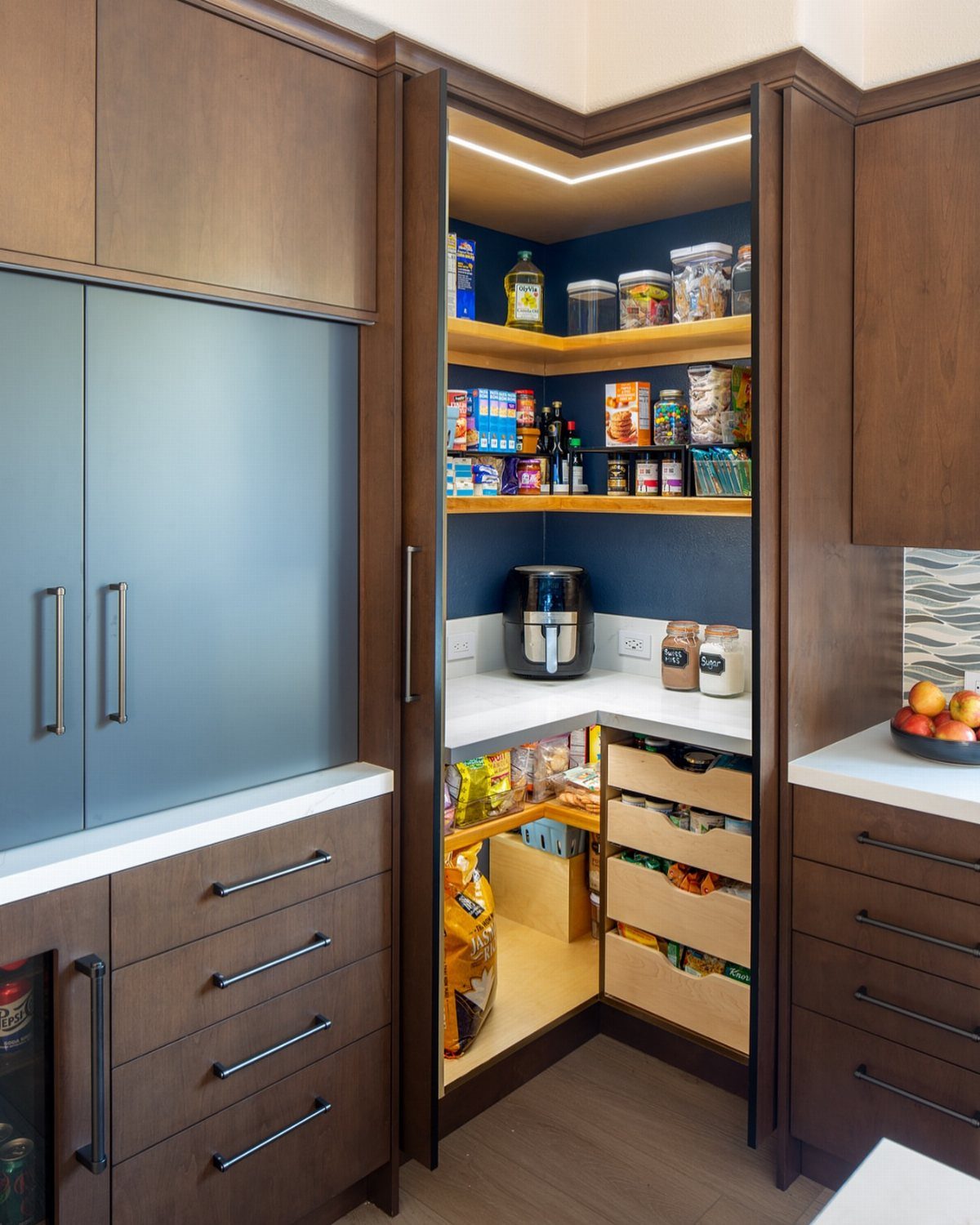 Tall corner pantry cabinet with shelves, coffee maker, and pull-out storage drawers.
