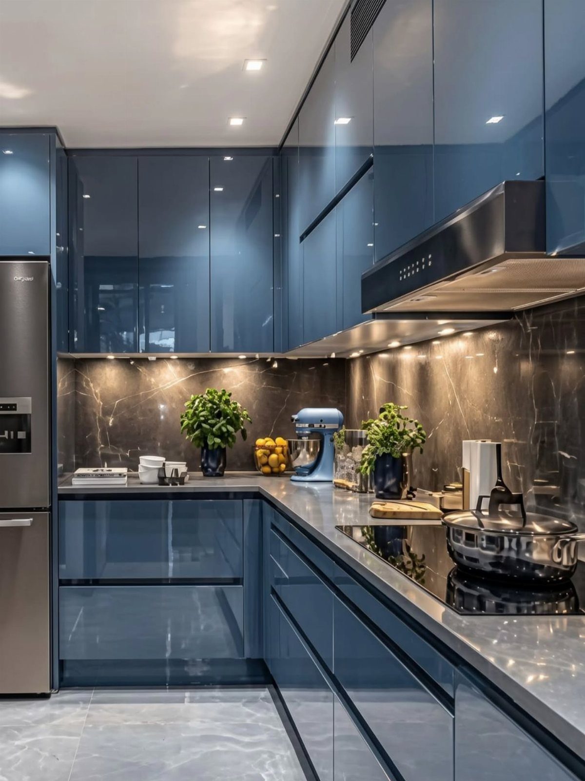 High-gloss dark blue kitchen cabinets with dark countertops and marble backsplash.