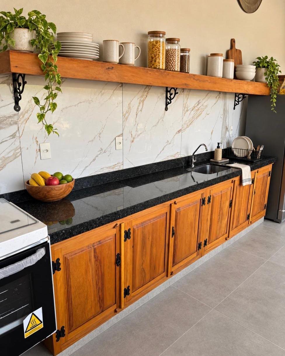 Wooden kitchen cabinets with black granite countertops and a white marble backsplash.