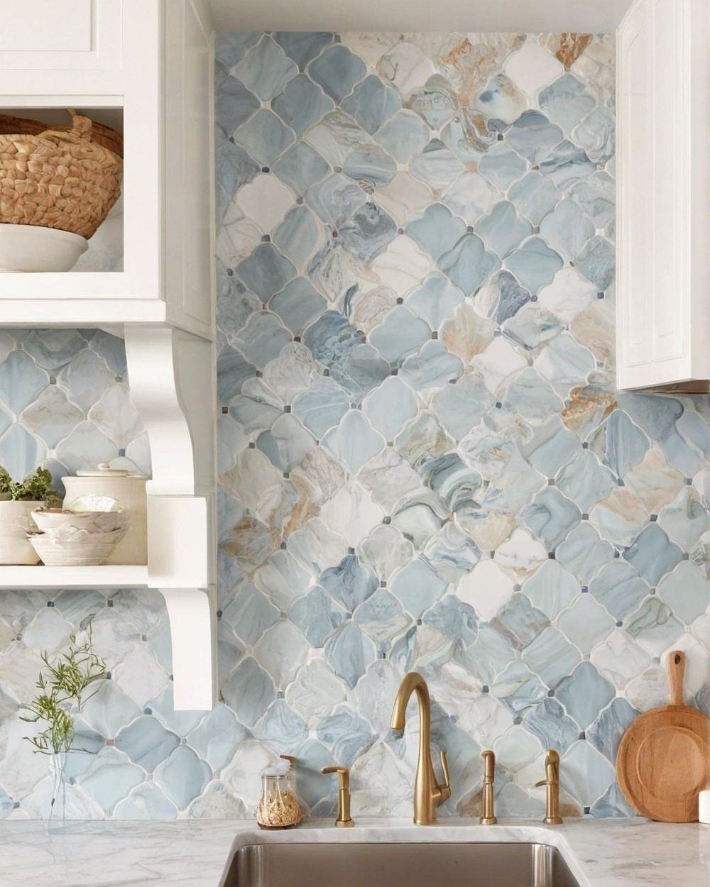Blue and white marble diamond mosaic backsplash with gold faucet and white cabinets