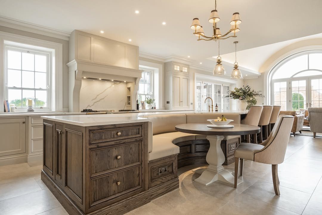 Dark oak kitchen island with built-in seating and a round dining table