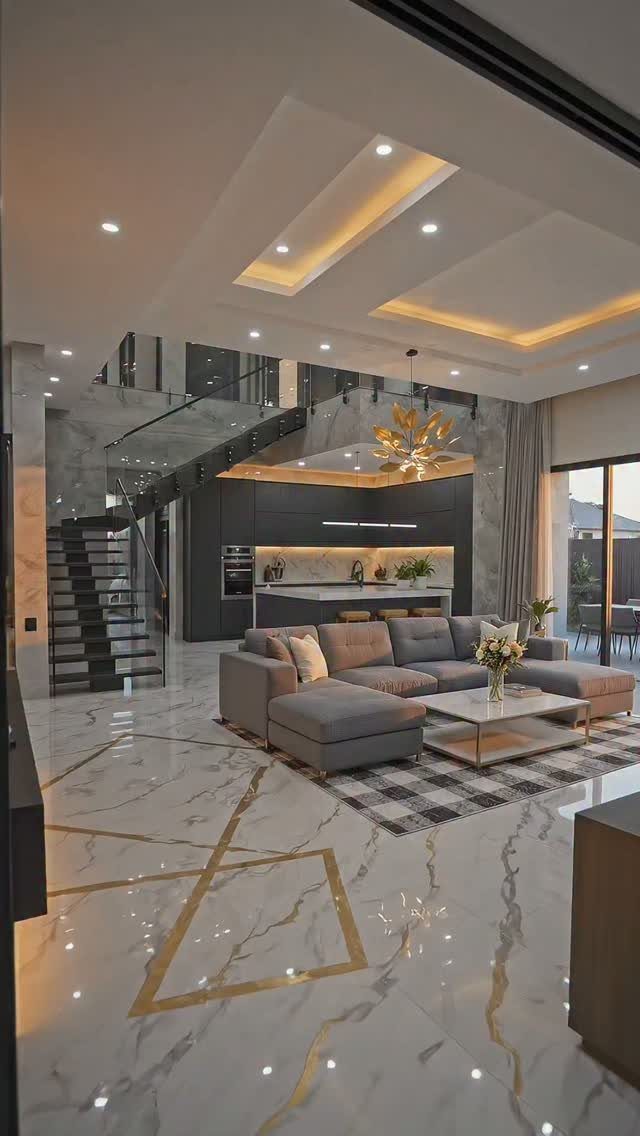 Modern open concept living room and kitchen with marble floors and grey furniture