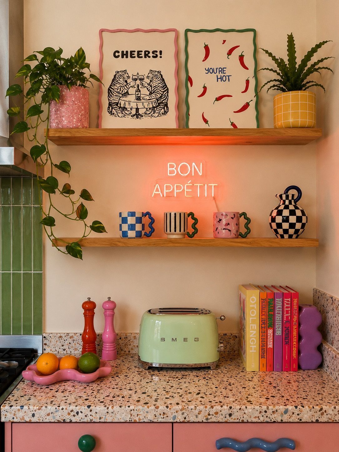Colorful kitchen counter with a light green toaster, vibrant cookbooks, and neon sign.