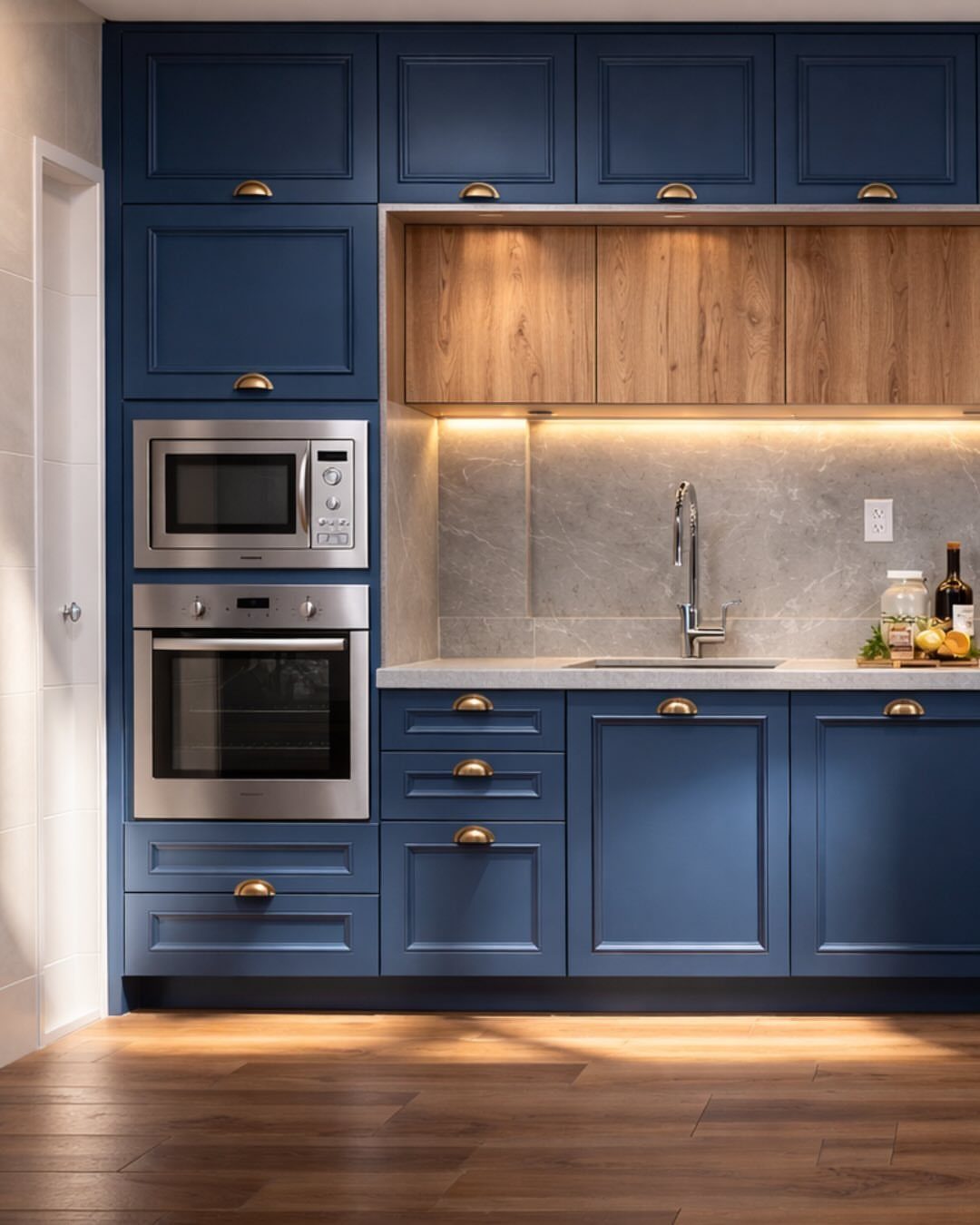 Navy blue kitchen cabinets with gold hardware and natural wood accents.