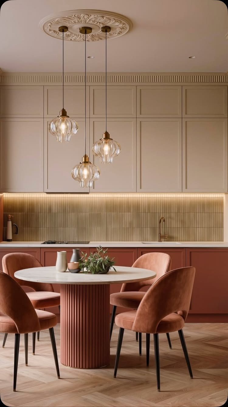 Cream and terracotta kitchen cabinets with a matching fluted dining table and chairs