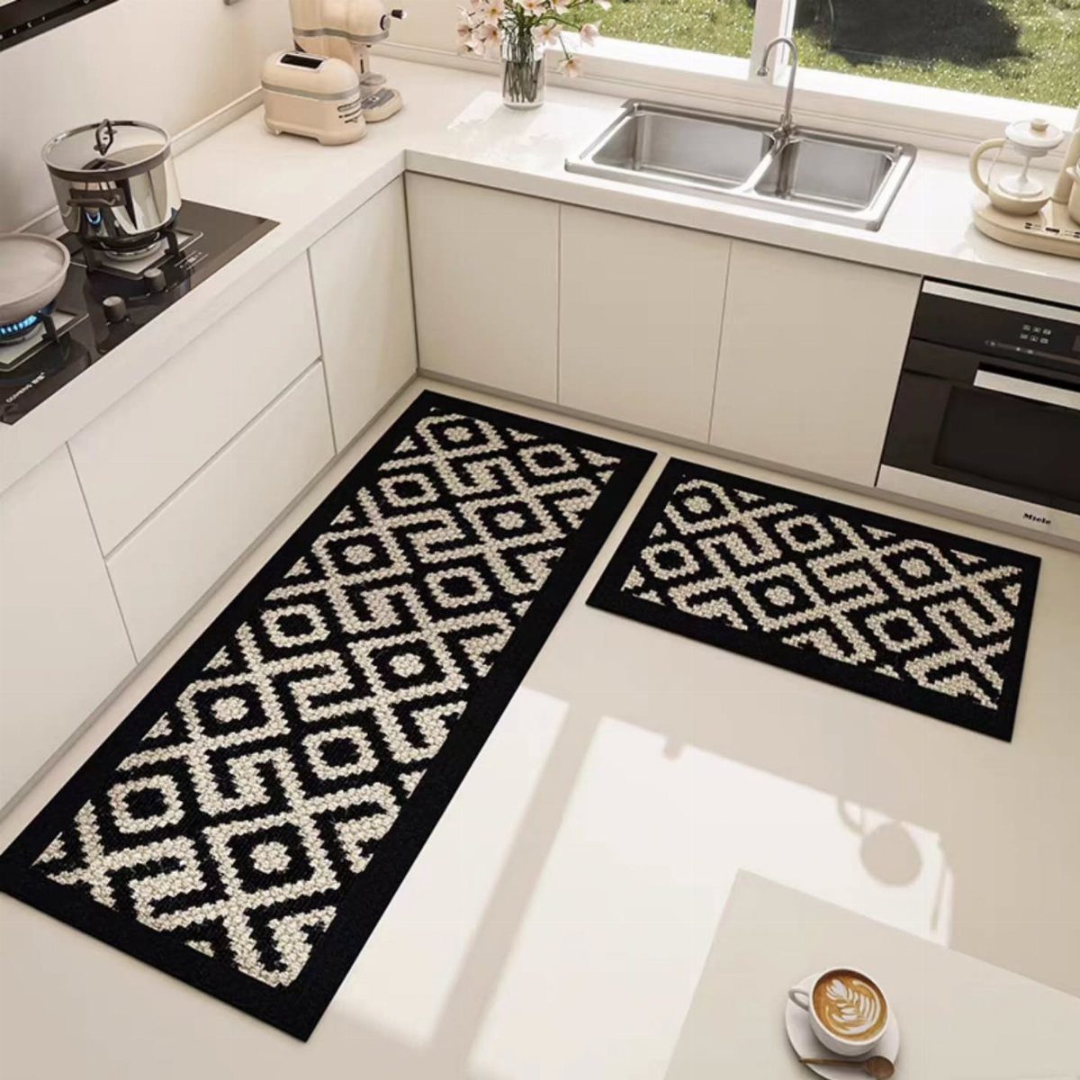 Black and white geometric rugs on a white floor in a modern kitchen