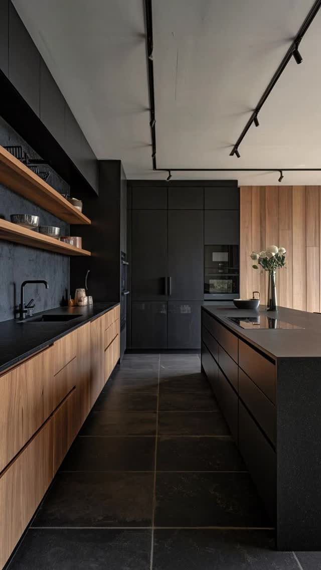 Modern kitchen with matte black cabinets and light wood lower cabinetry and shelving.