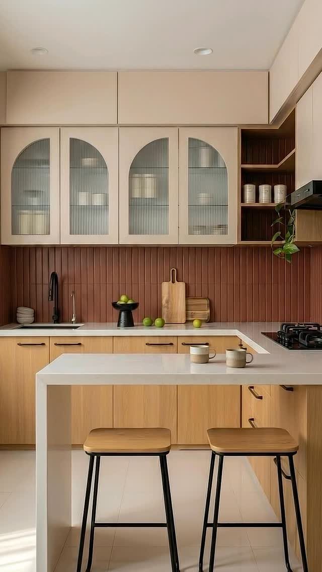 Beige upper cabinets with fluted glass and open wooden shelving in a kitchen.