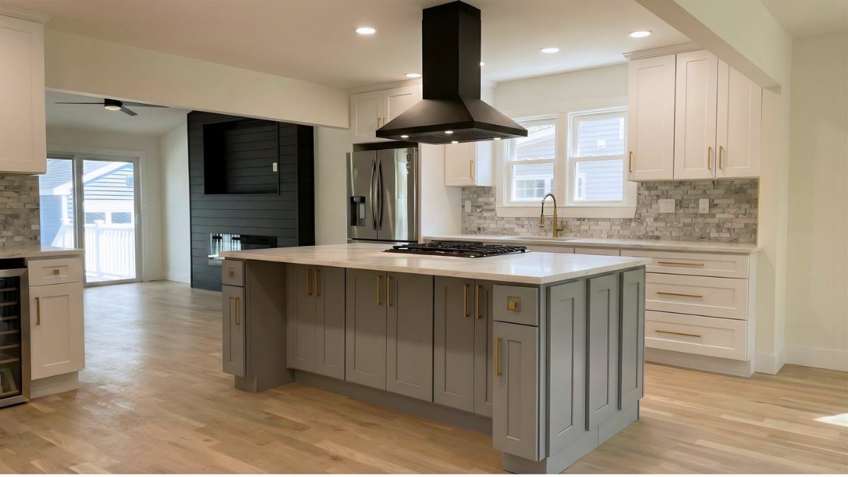 Grey kitchen island with white countertop centered in a white modern kitchen