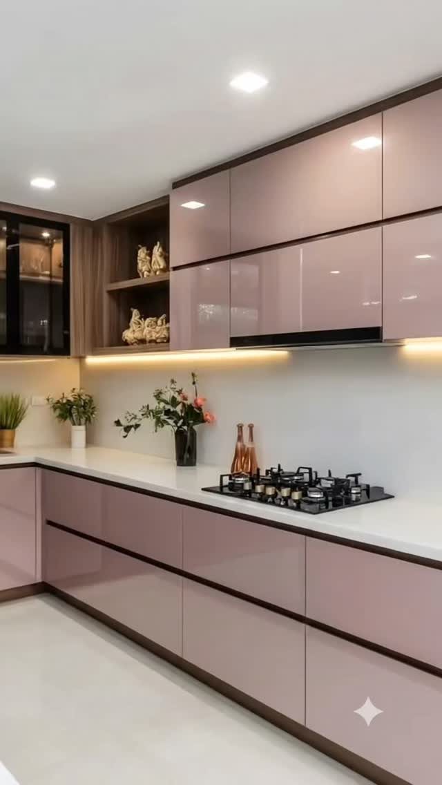 Glossy mauve-pink kitchen cabinets paired with matte brown wooden open shelving and white countertops.