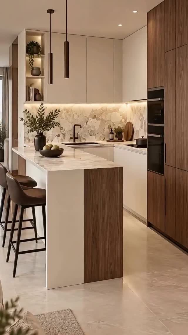 Modern kitchen with two-tone walnut and white cabinets and a marble island.