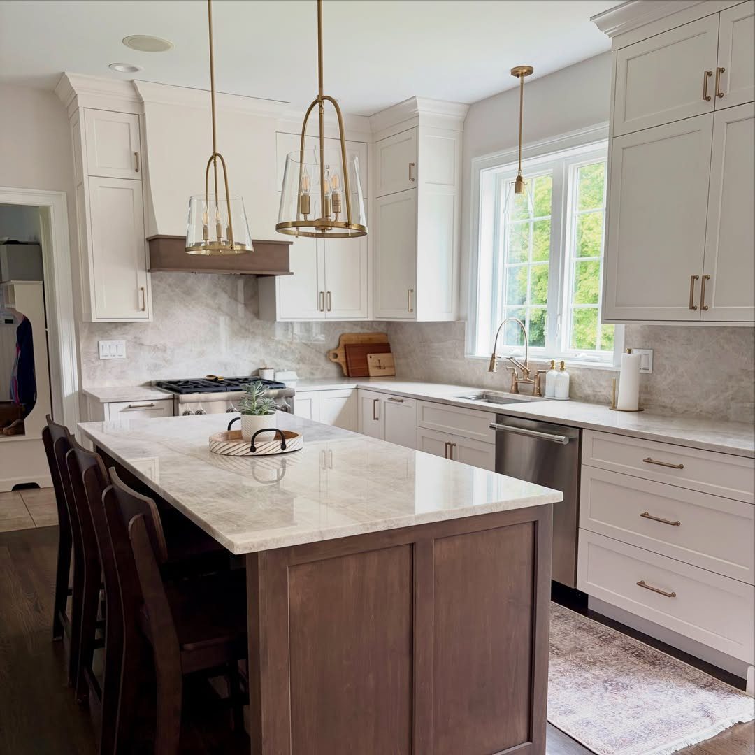 Modern kitchen with white cabinetry and a dark walnut wood center island.