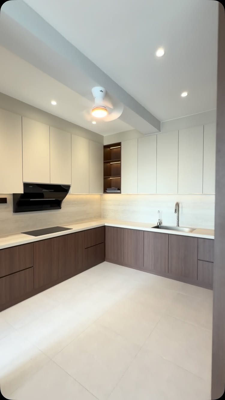 Two-tone kitchen with white upper cabinets and dark brown wood lower cabinets.